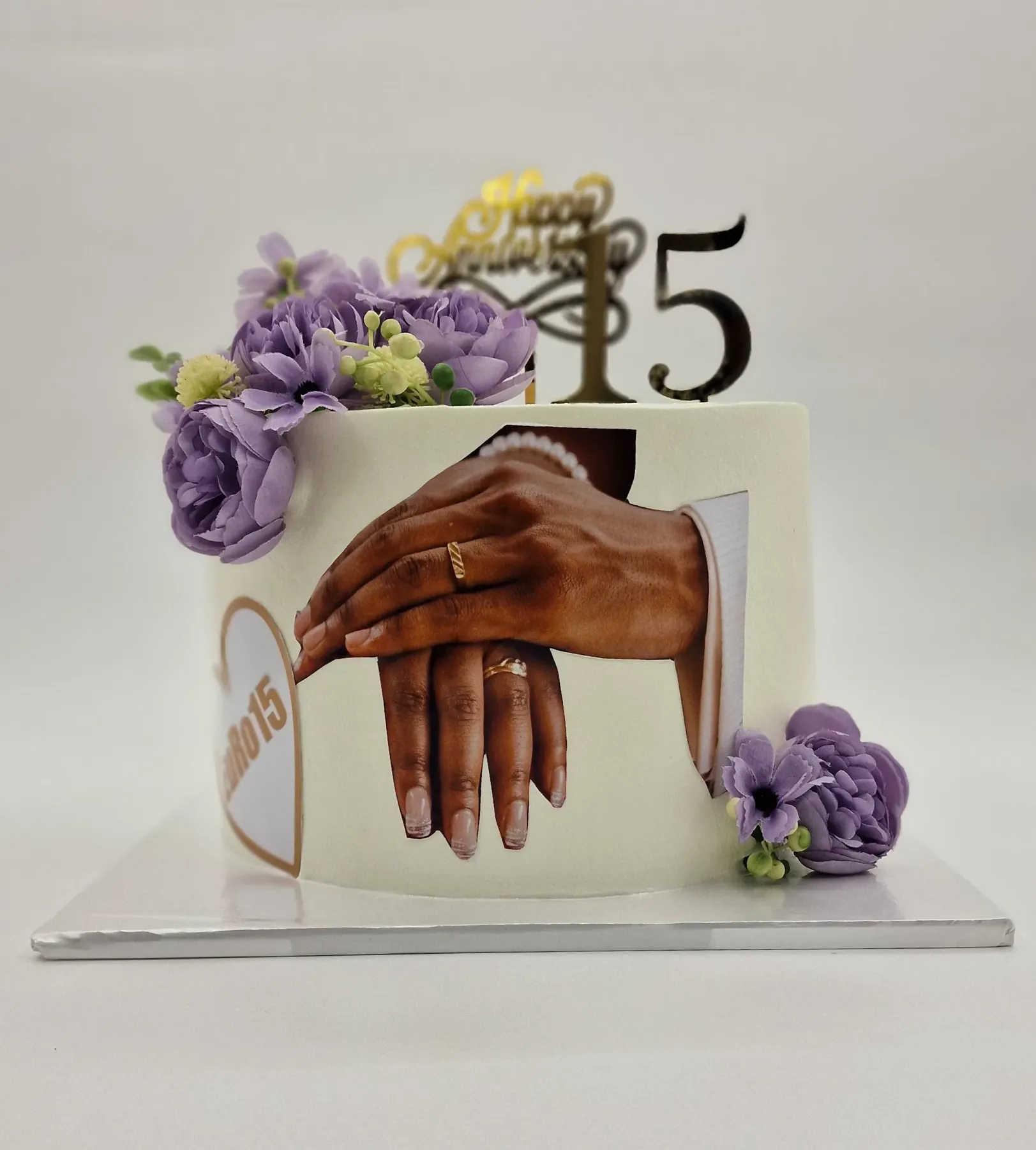 A custom celebration cake by The Cake Studio Harare available in an eggless version, with edible-print detail and lavender sugar peonies
