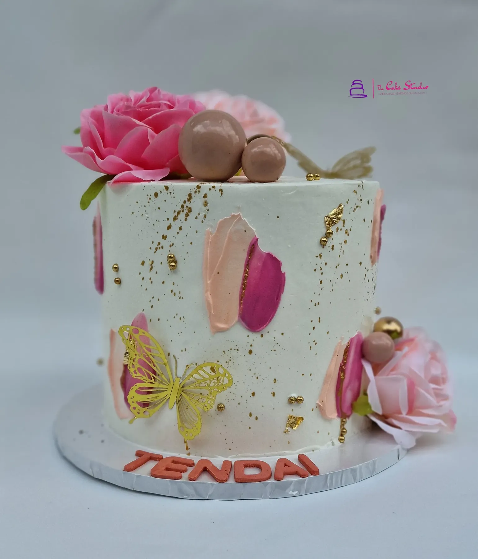 A carrot cake with cream cheese frosting and walnut detail, baked by The Cake Studio Harare