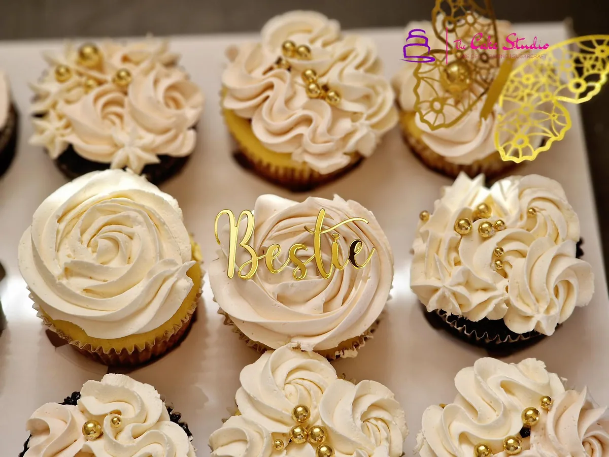 Blush pink rose cupcakes finished with gold pearls and a personalised monogram topper, baked by The Cake Studio Harare
