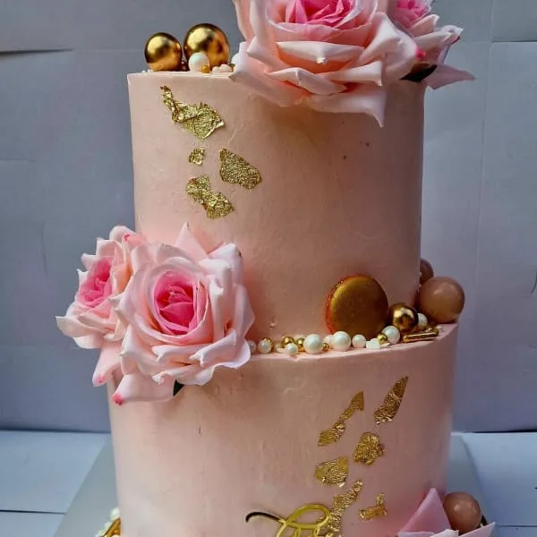 A two-tier blush celebration cake by a Harare cake shop