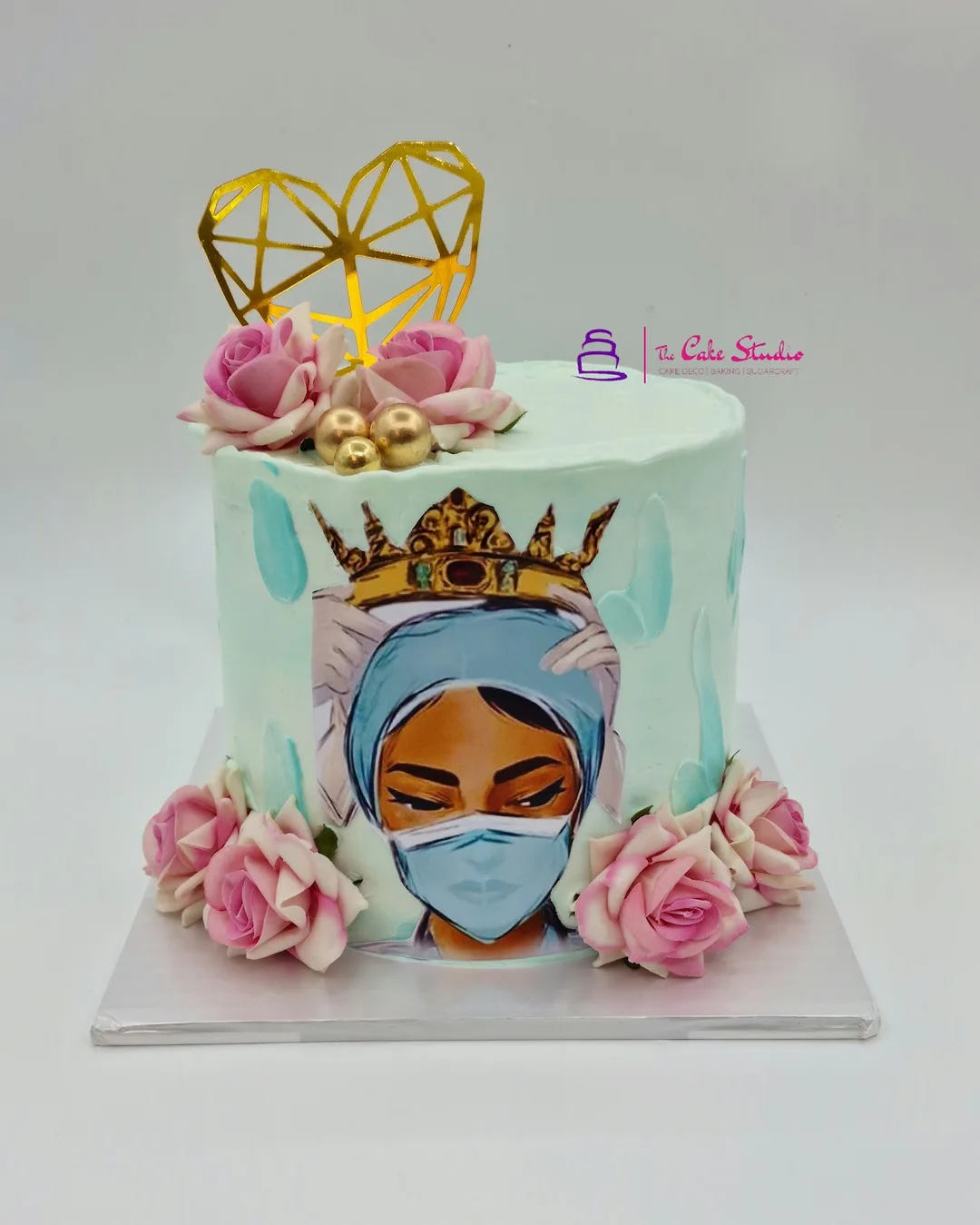 A hand-painted cake featuring an African queen with a gold crown