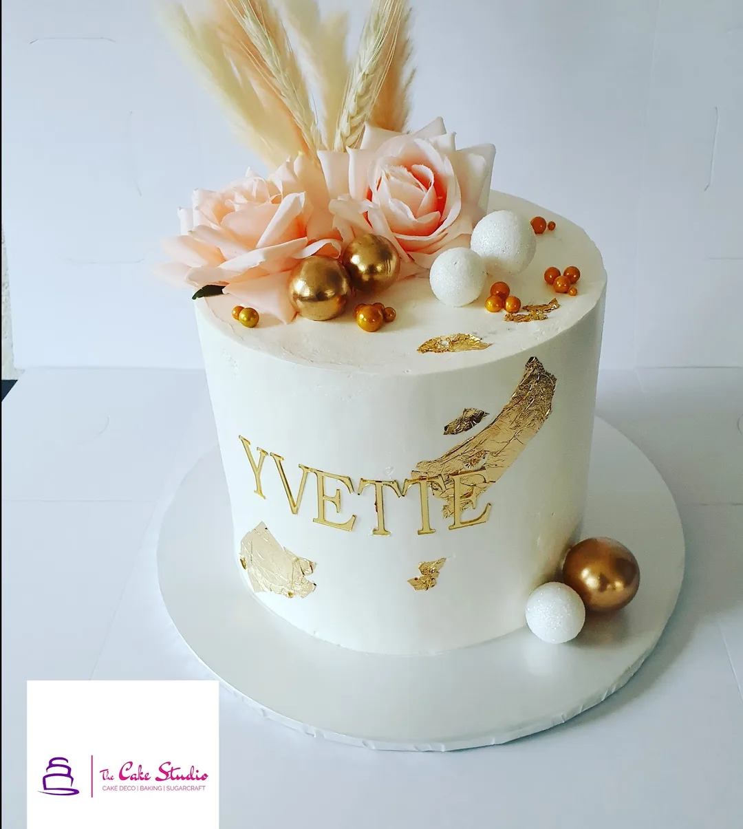 An ivory celebration cake with pampas and roses