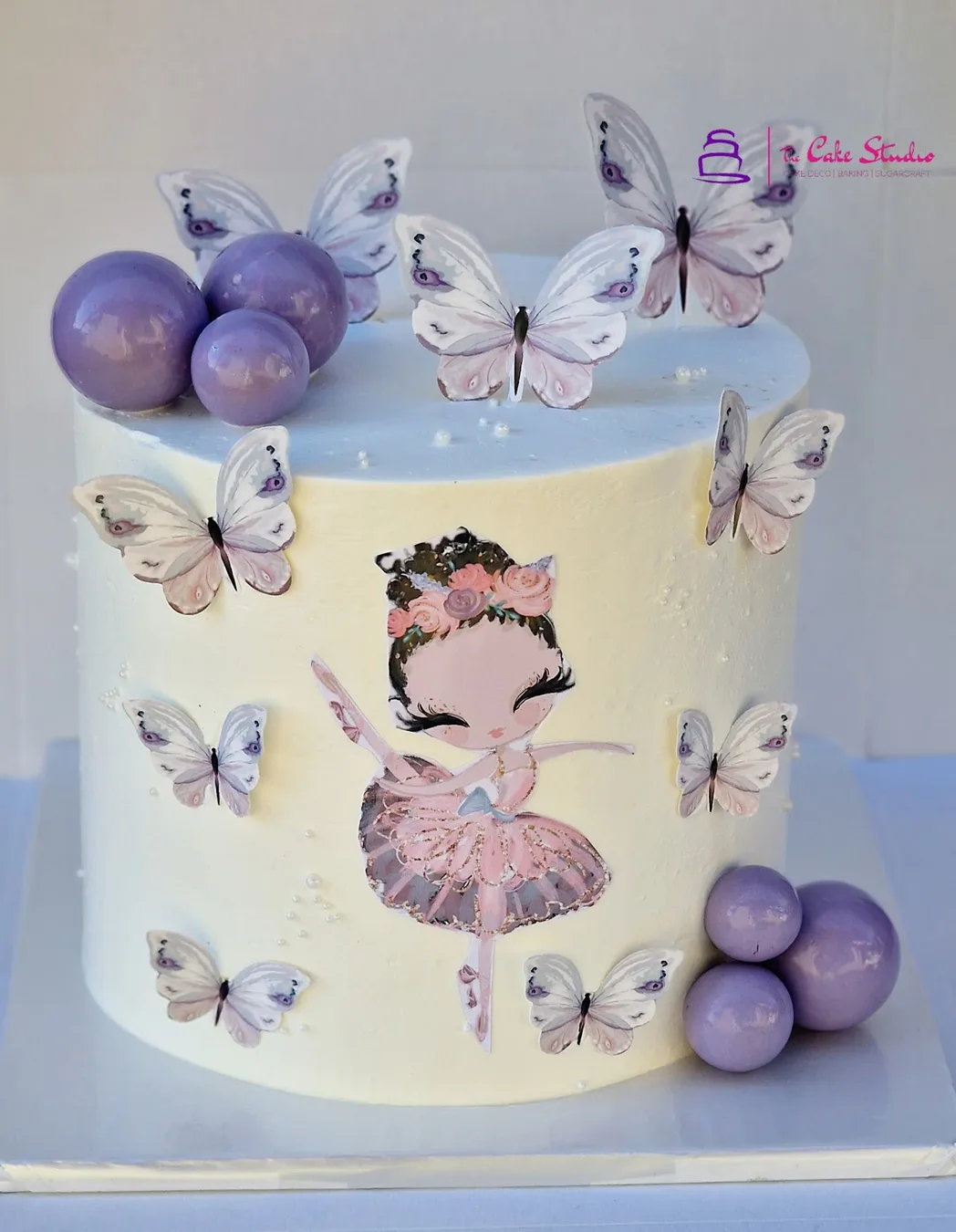 A white ballerina cake with sugar butterflies