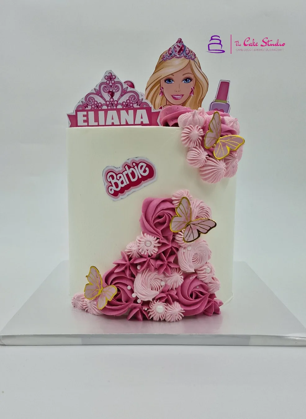 A pink Barbie themed birthday cake