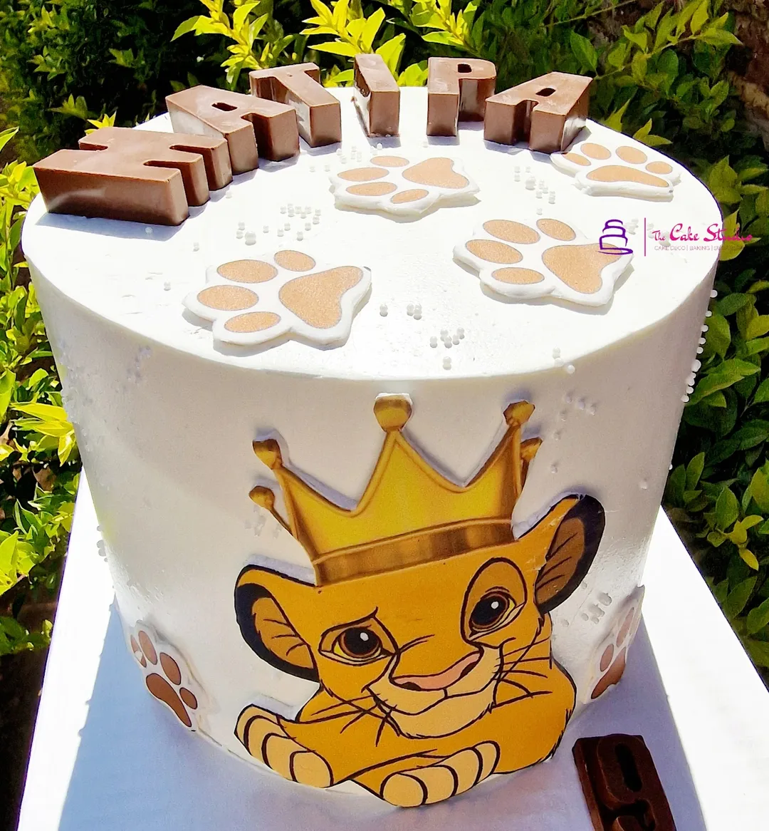 A Lion King themed cake with a hand-painted Simba
