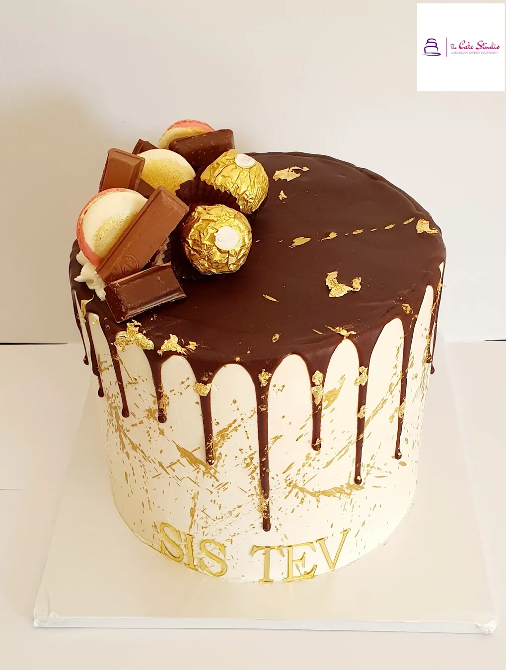 A chocolate drip cake topped with Ferrero and Kinder