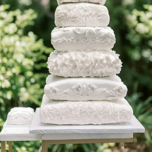 A tall five-tier white wedding cake