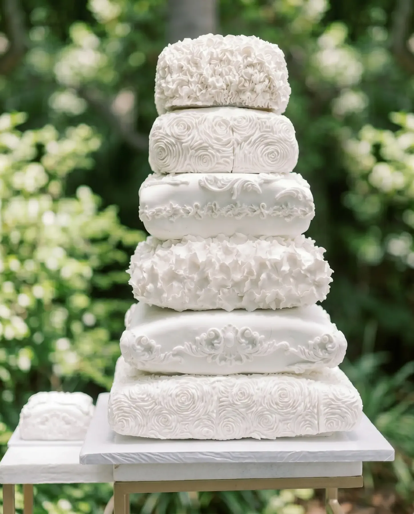 A classic white wedding cake with a sugar flower cascade